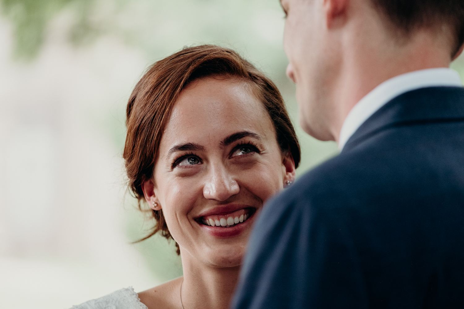 bride watches groom during wedding vows