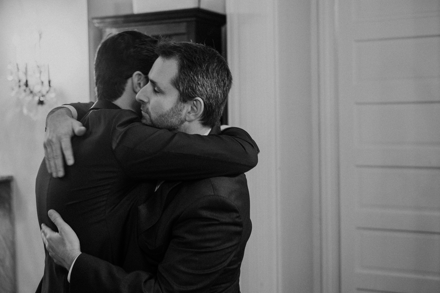 groom and brother hug before wedding