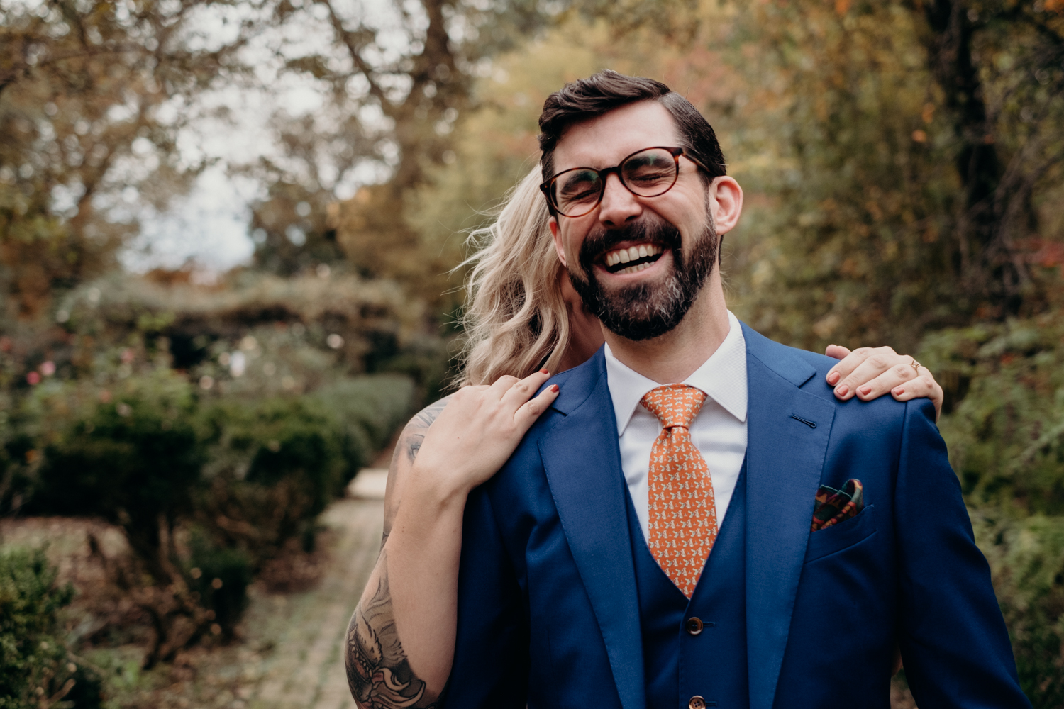 groom laughs with joy right before seeing his bride during their first look in dc intimate wedding