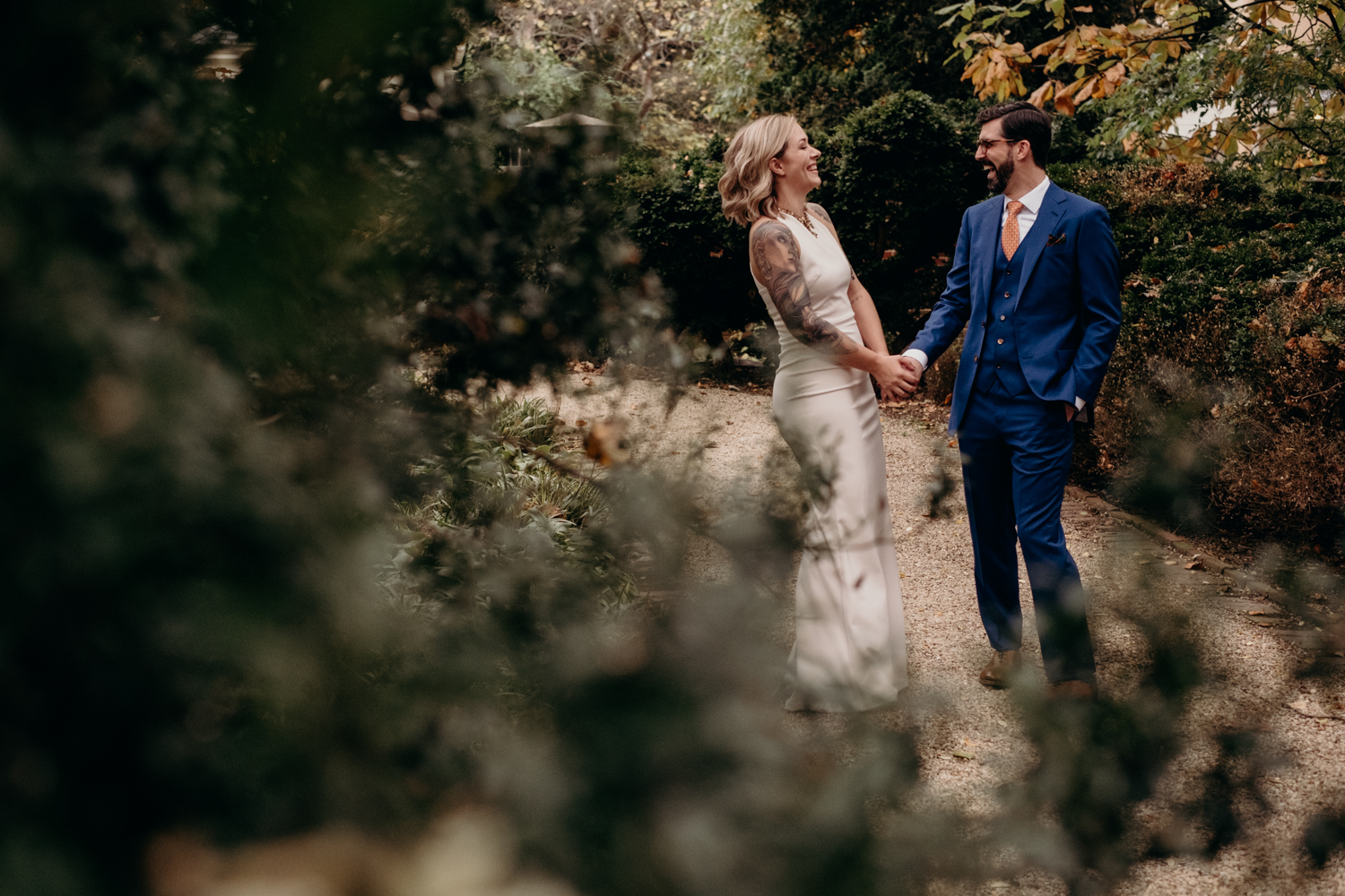 couple waits just before the start of their wedding in the gardens