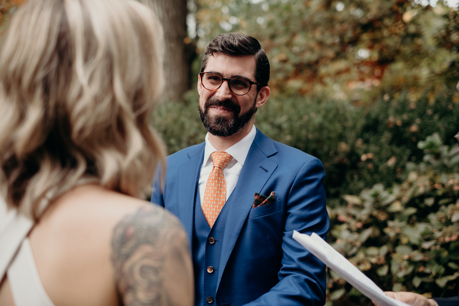 groom listens to wedding vows