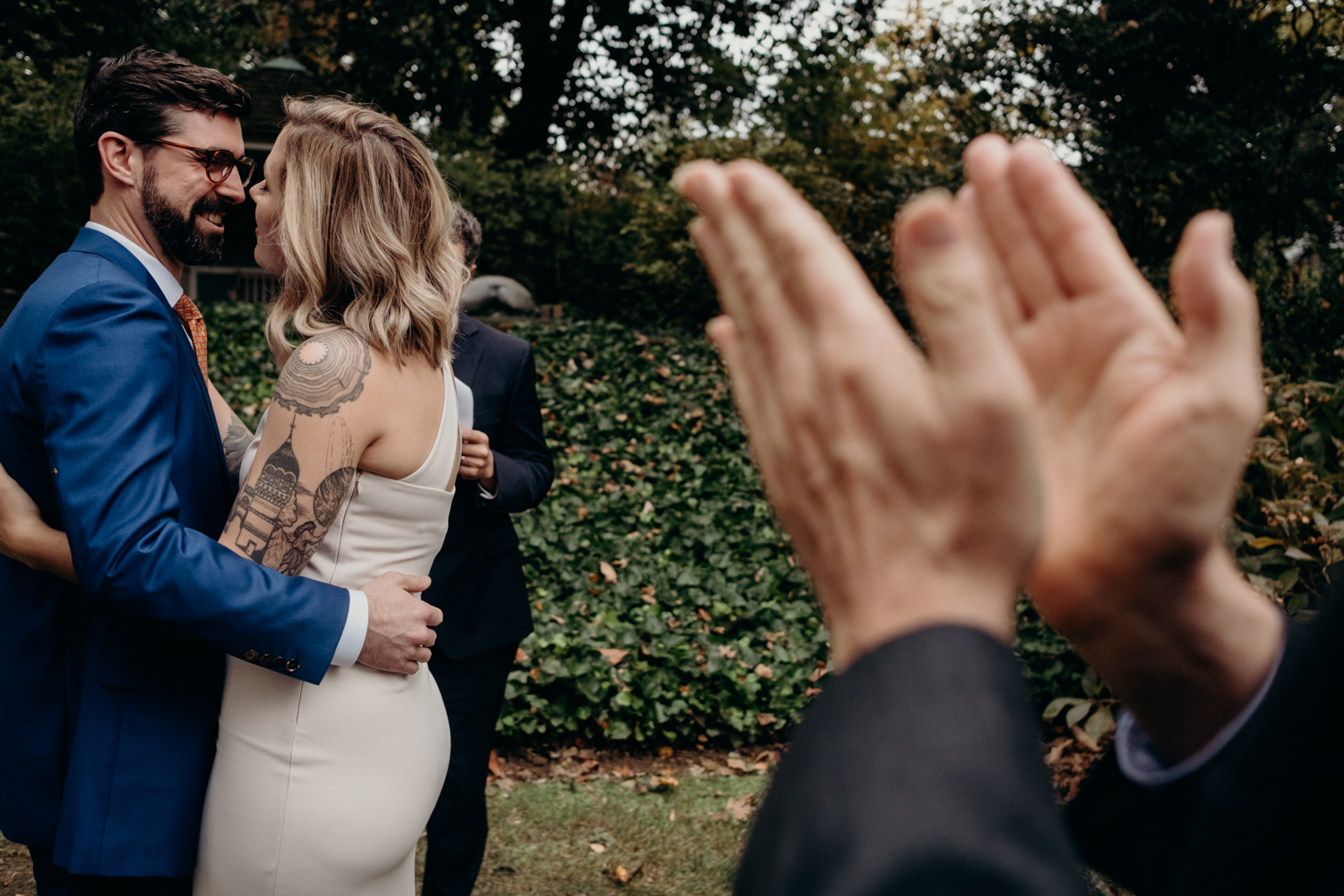 groom's father claps during the first kiss at the end of an intimate dc wedding