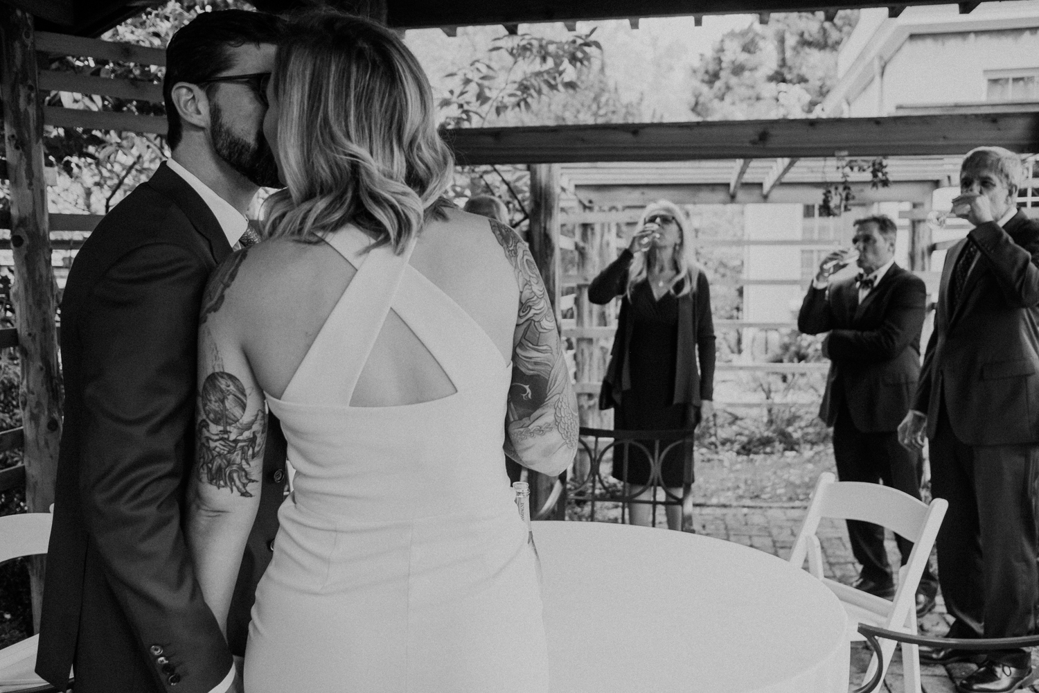 bride and groom kiss during toasts