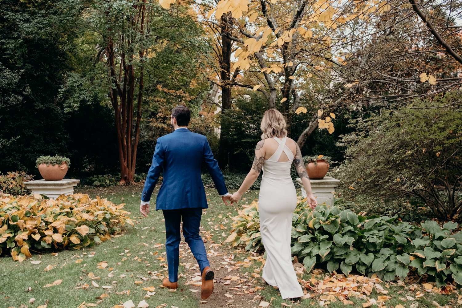 wedding couple walking through tudor place gardens