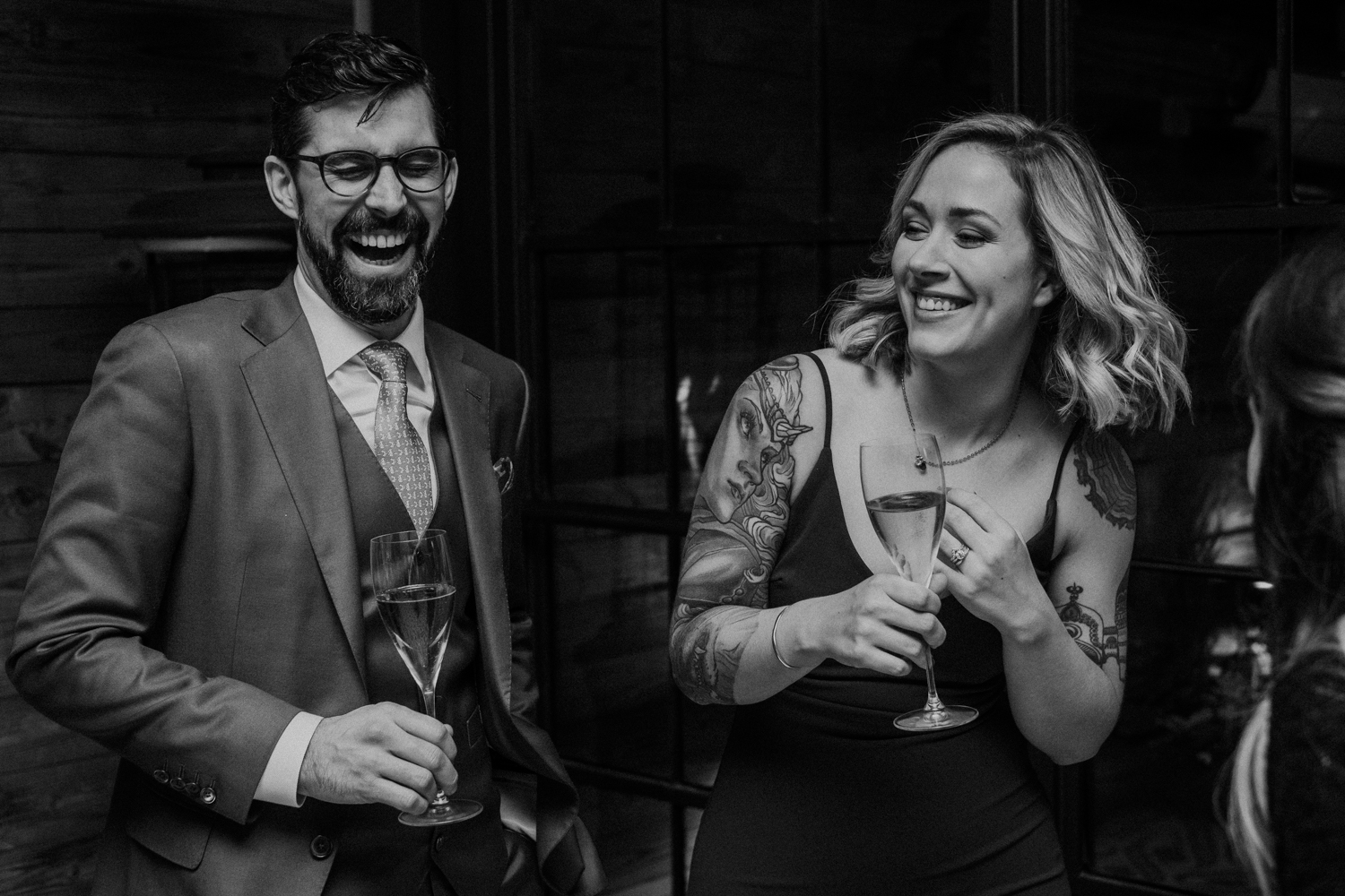 bride and groom laughing during toasts at their wedding