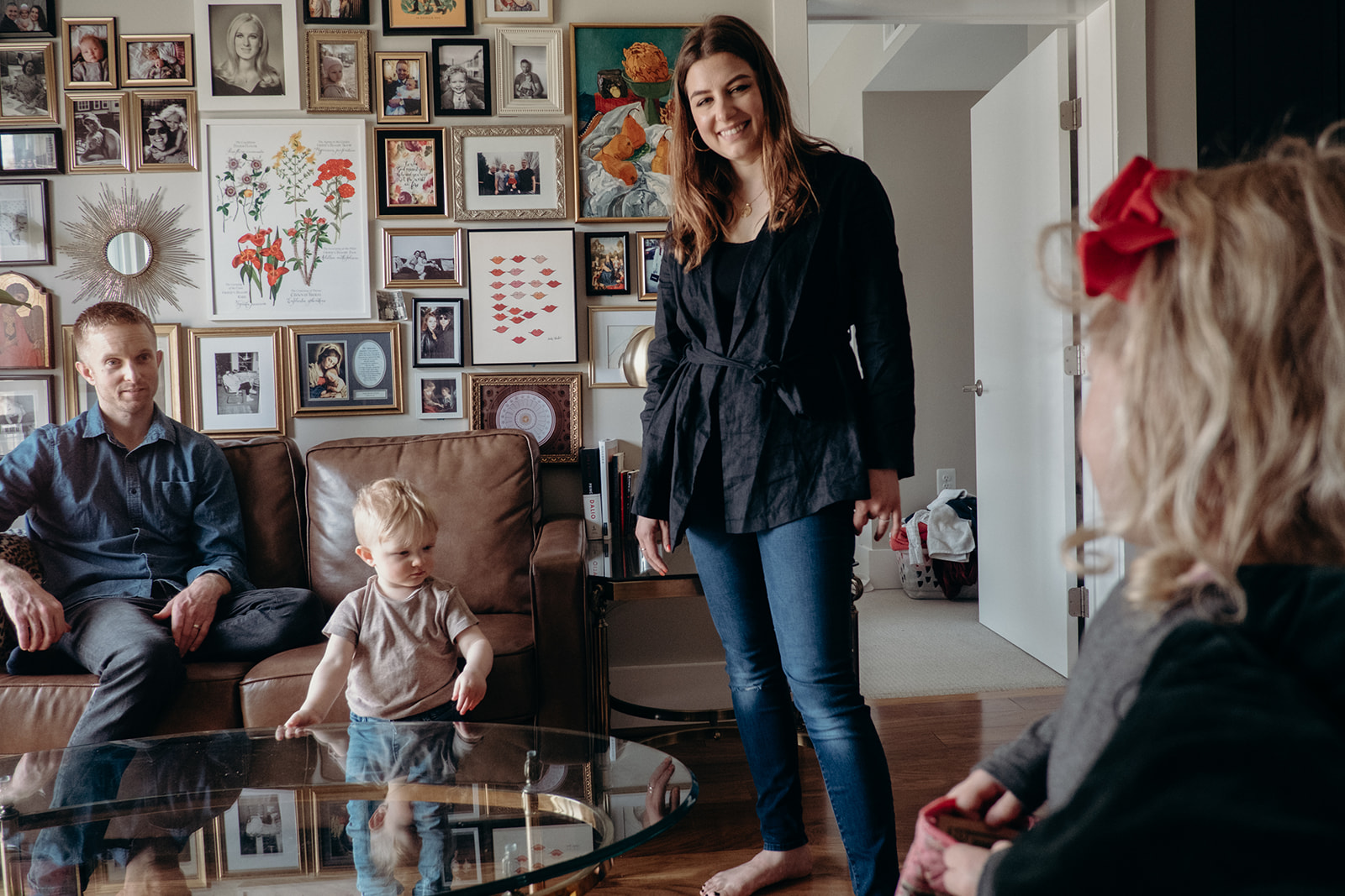 A mother and father look at their daughter while she talks in their apartment in Washington, DC.