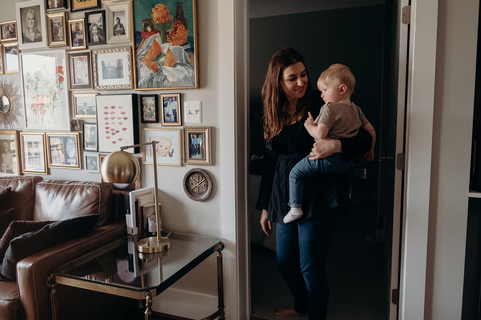 A mother holds her little boy before putting him down for a nap in their apartment in Washington, DC.