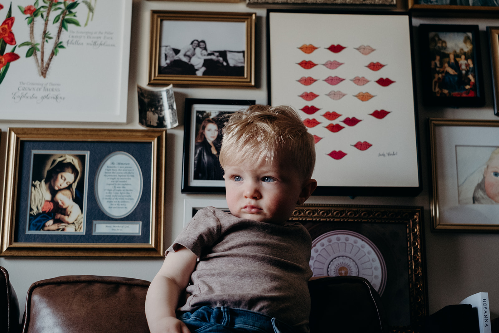 A little boy stands on a couch in his family apartment in Washington, DC.