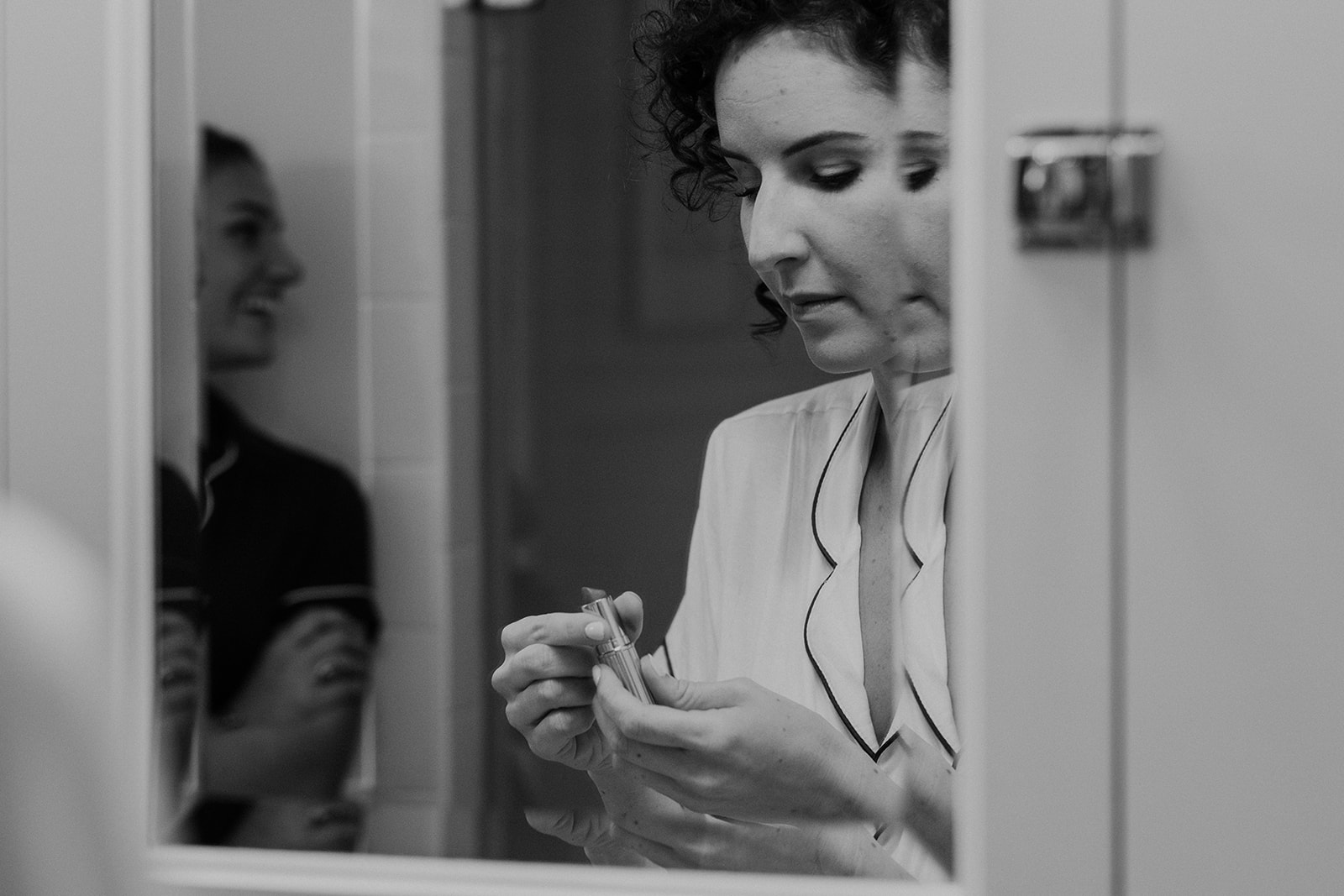 A bride applies lipstick before her outdoor wedding ceremony at Blue Hill Farm in Waterford, VA. 