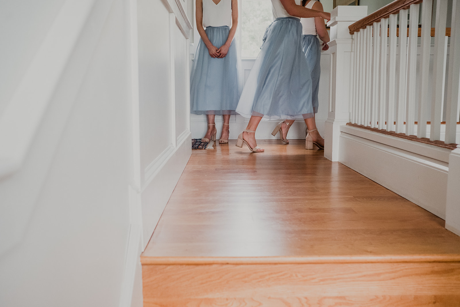 Bridesmaids in blue tulle skirts rush around for last minute touches before an outdoor wedding ceremony at Blue Hill Farm in Waterford, VA. 