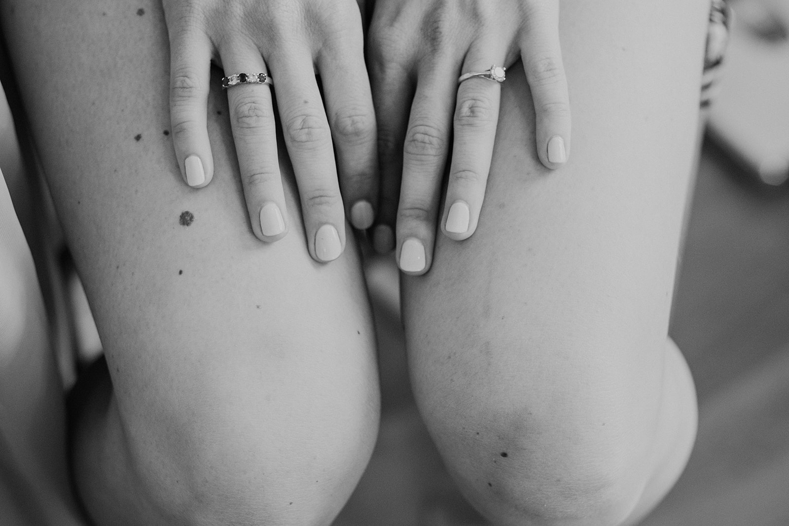 A bride rests her hands on her lap and her engagement ring is visible while she is getting ready before her outdoor wedding ceremony at Blue Hill Farm in Waterford, VA.