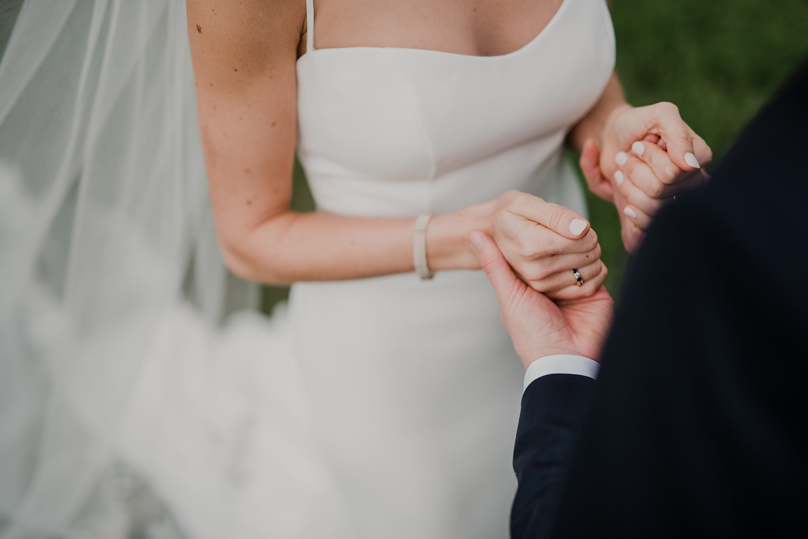 A bride and groom join hands during their first look before their outdoor wedding ceremony at Blue Hill Farm in Waterford, VA. 