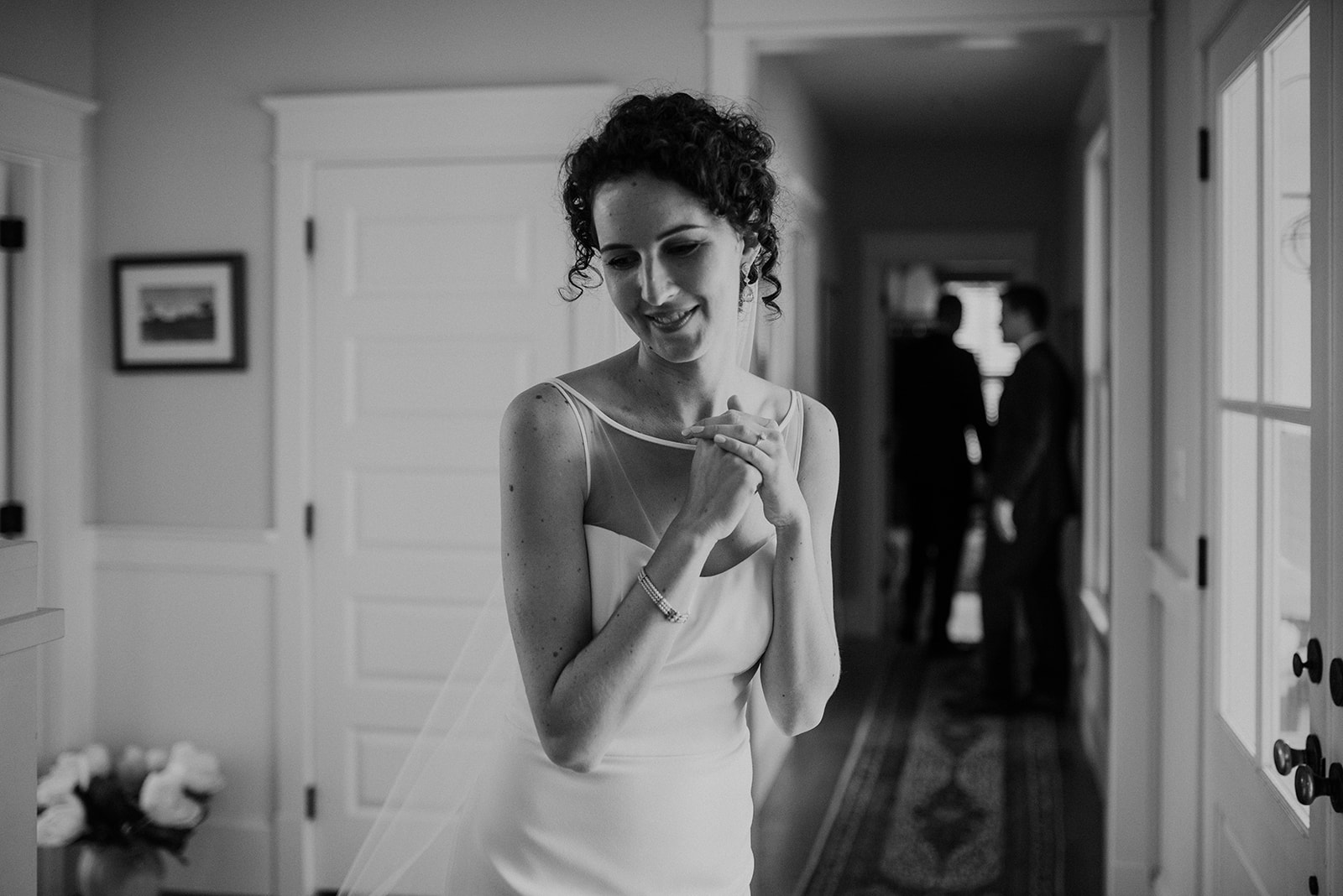 A bride smiles to herself as she prepares to walk down the aisle at her outdoor wedding ceremony at Blue Hill Farm in Waterford, VA. 