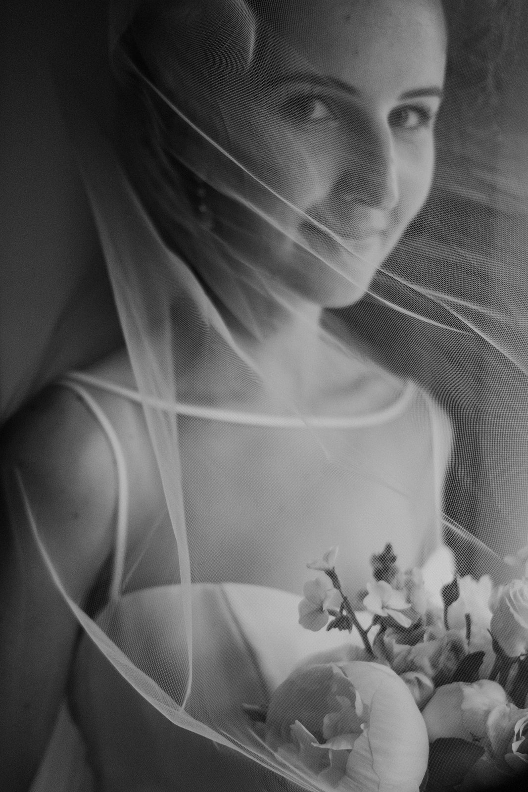 A bride looks through her veil before she heads down the aisle at her outdoor wedding ceremony at Blue Hill Farm in Waterford, VA.