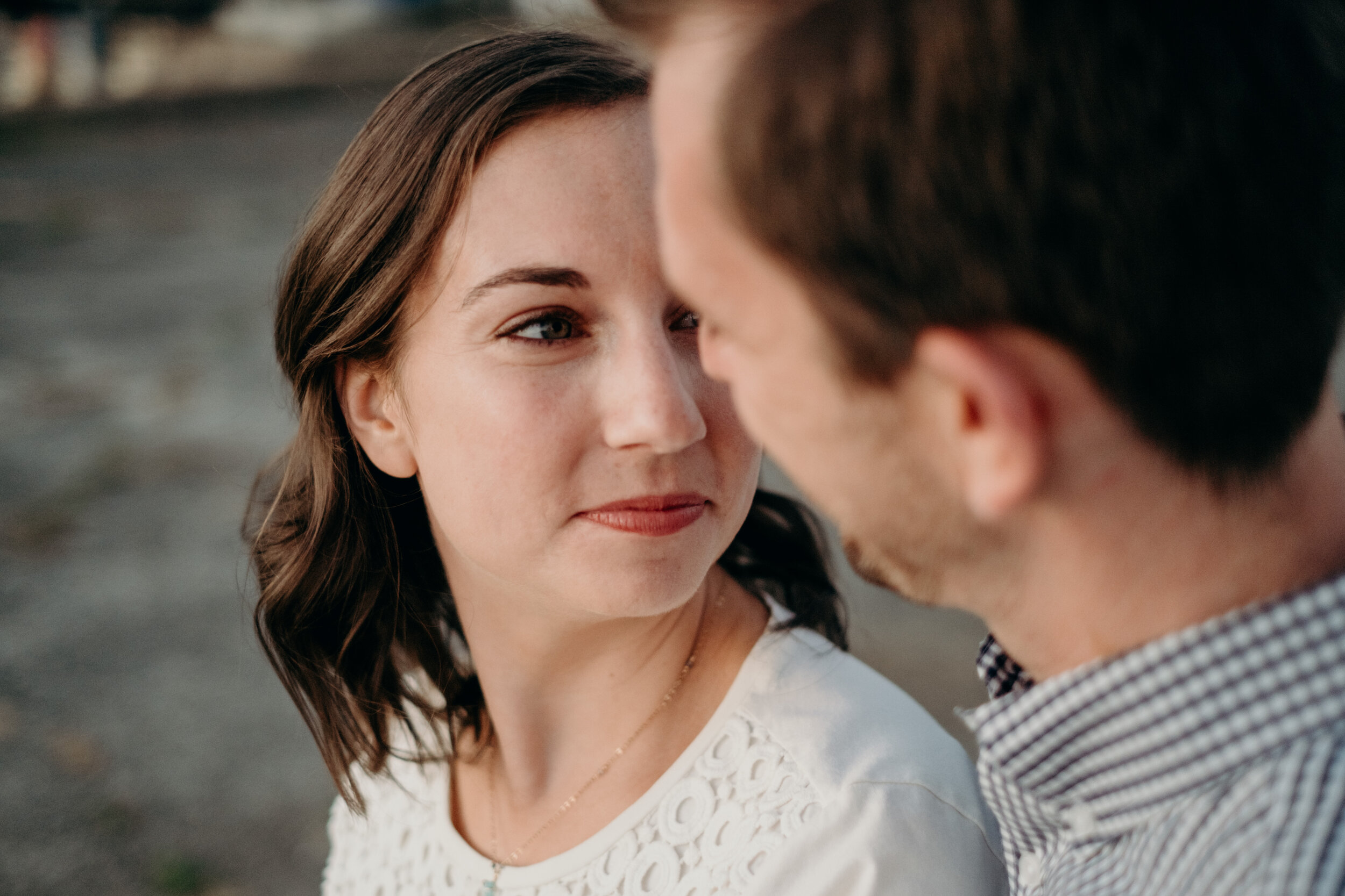 A woman looks at her fiancé during their engagement session in Baltimore, MD. 