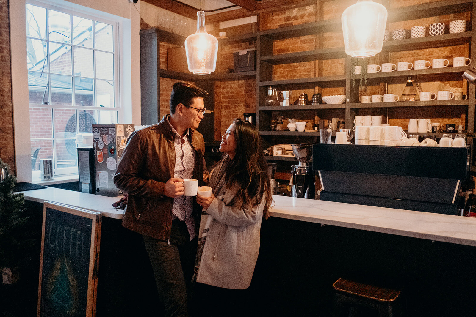 An engaged couple share a coffee at the espresso bar at SideBar coffee in downtown Leesburg, VA. 