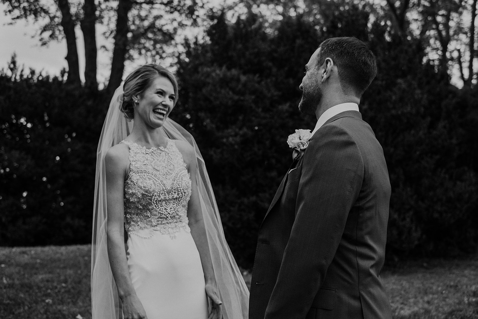 A bride and groom behold each other during their first look before their outdoor garden wedding at the Retreat at Eastwood Farm in Warrenton, VA. 