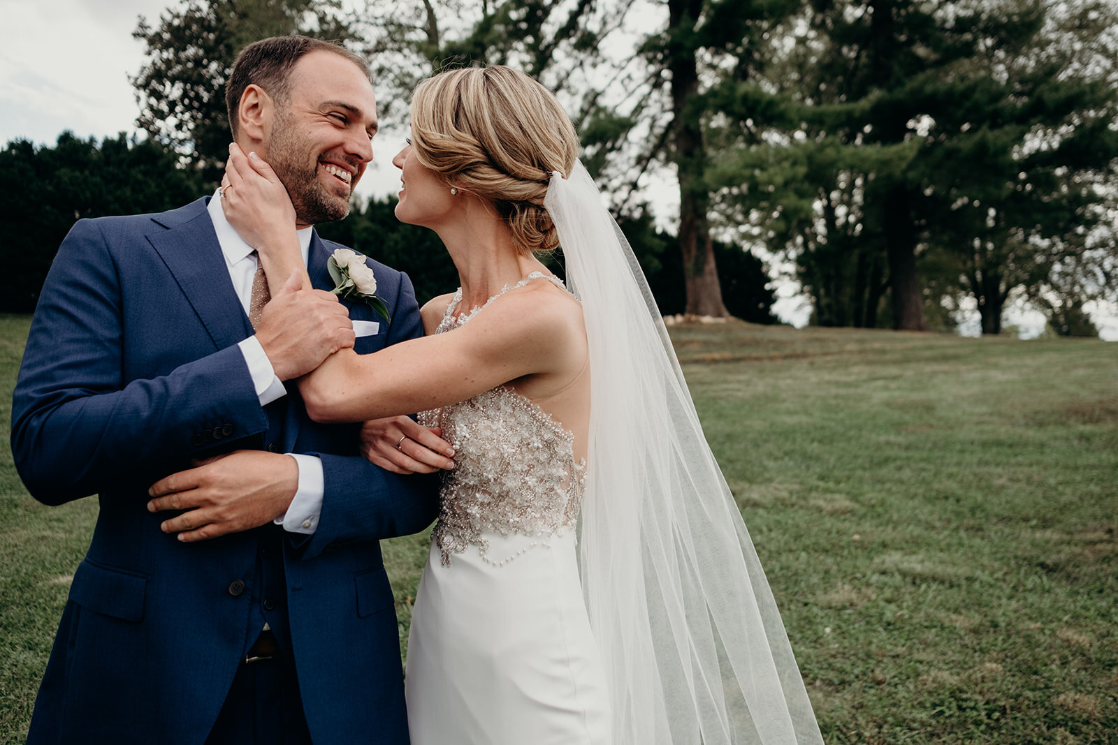 A bride and groom embrace after their first look before their outdoor garden wedding at the Retreat at Eastwood Farm in Warrenton, VA.