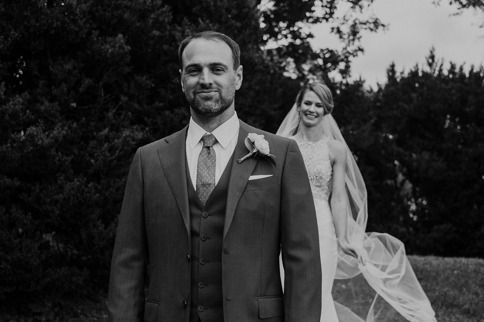 A groom is waiting for his bride during their first look before their outdoor garden wedding at the Retreat at Eastwood Farm in Warrenton, VA. 