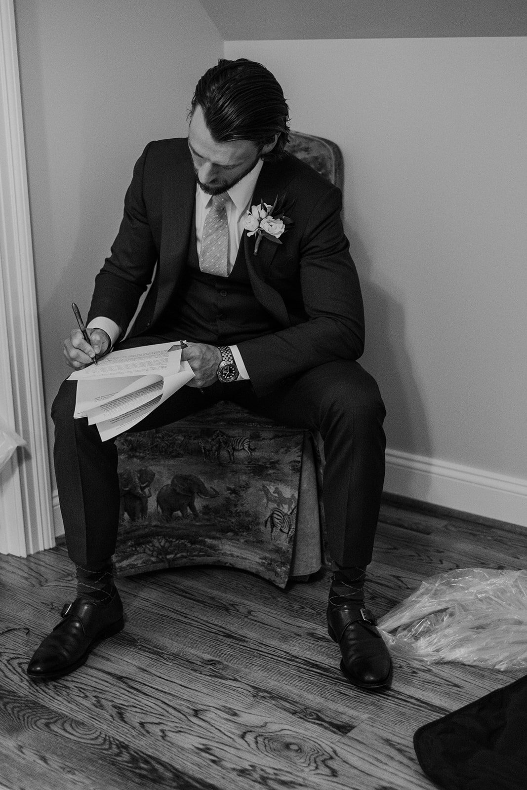 A groomsman rewrites his speech before an outdoor garden wedding at the Retreat at Eastwood in Warrenton, VA. 