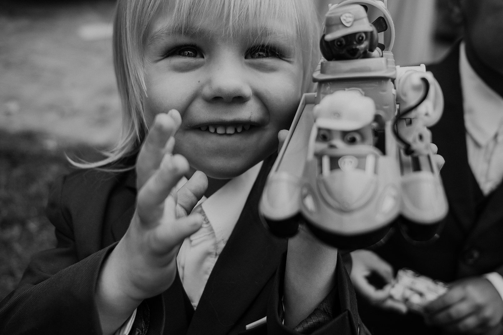 A little ringbearer shows off his toy at an outdoor garden wedding at the Retreat at Eastwood Farm in Warrenton, VA.