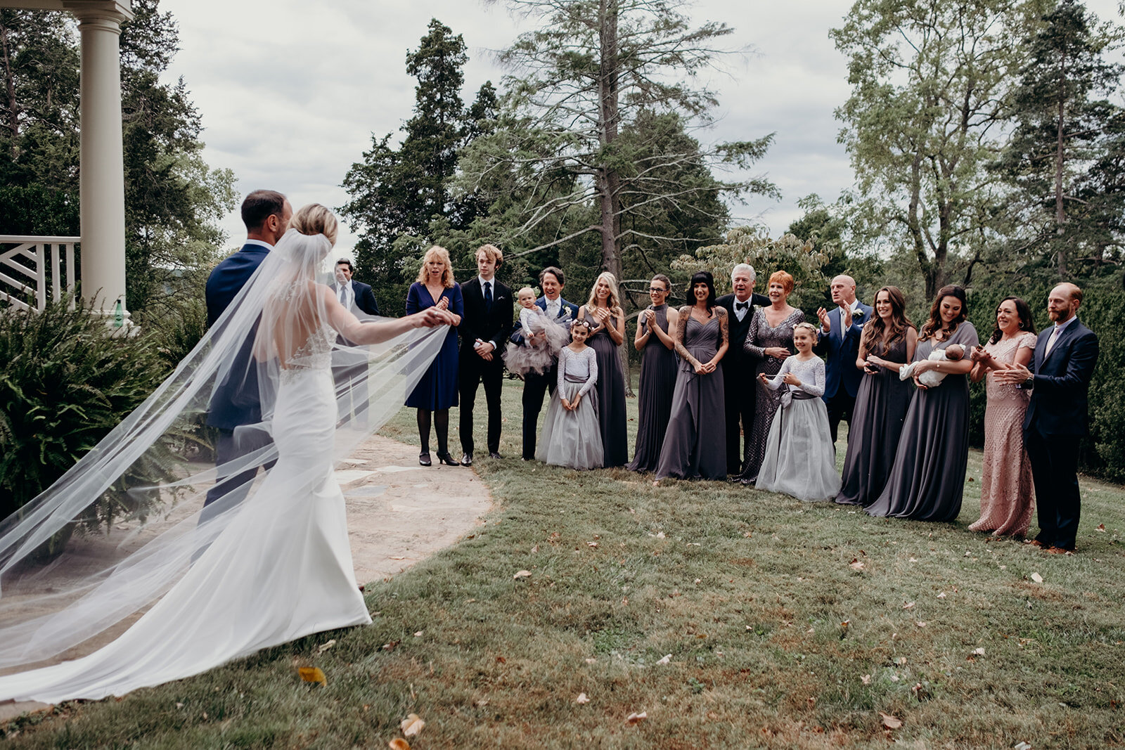 A bride and groom greet their families before their outdoor garden wedding at the Retreat at Eastwood Farm in Warrenton, VA.