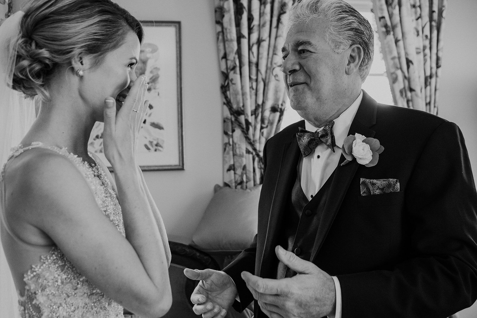 A bride wipes away a tear after seeing her father for the first time on her wedding day at the Retreat at Eastwood Farm in Warrenton, VA.