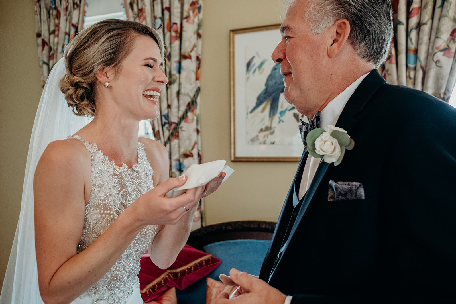 A bride wipes a tear away with a handkerchief after seeing her dad for the first time on her wedding day at the Retreat at Eastwood Farm in Warrenton, VA.