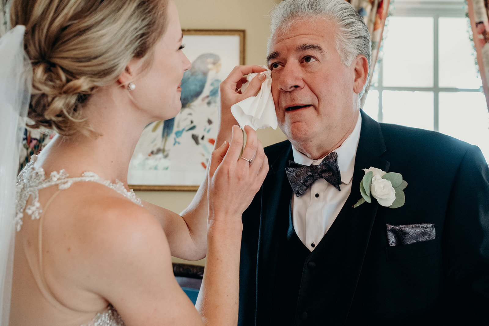 A bride wipes away a tear on her father's cheek after he sees her for the first time on her wedding day at The Retreat at Eastwood Farm in Warrenton, VA.