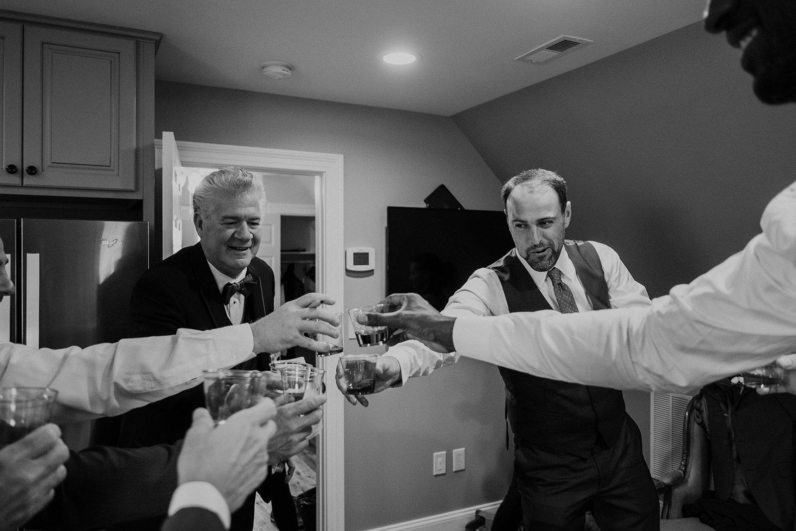 Groomsmen make a toast before an outdoor garden wedding at the Retreat at Eastwood in Warrenton, VA. 