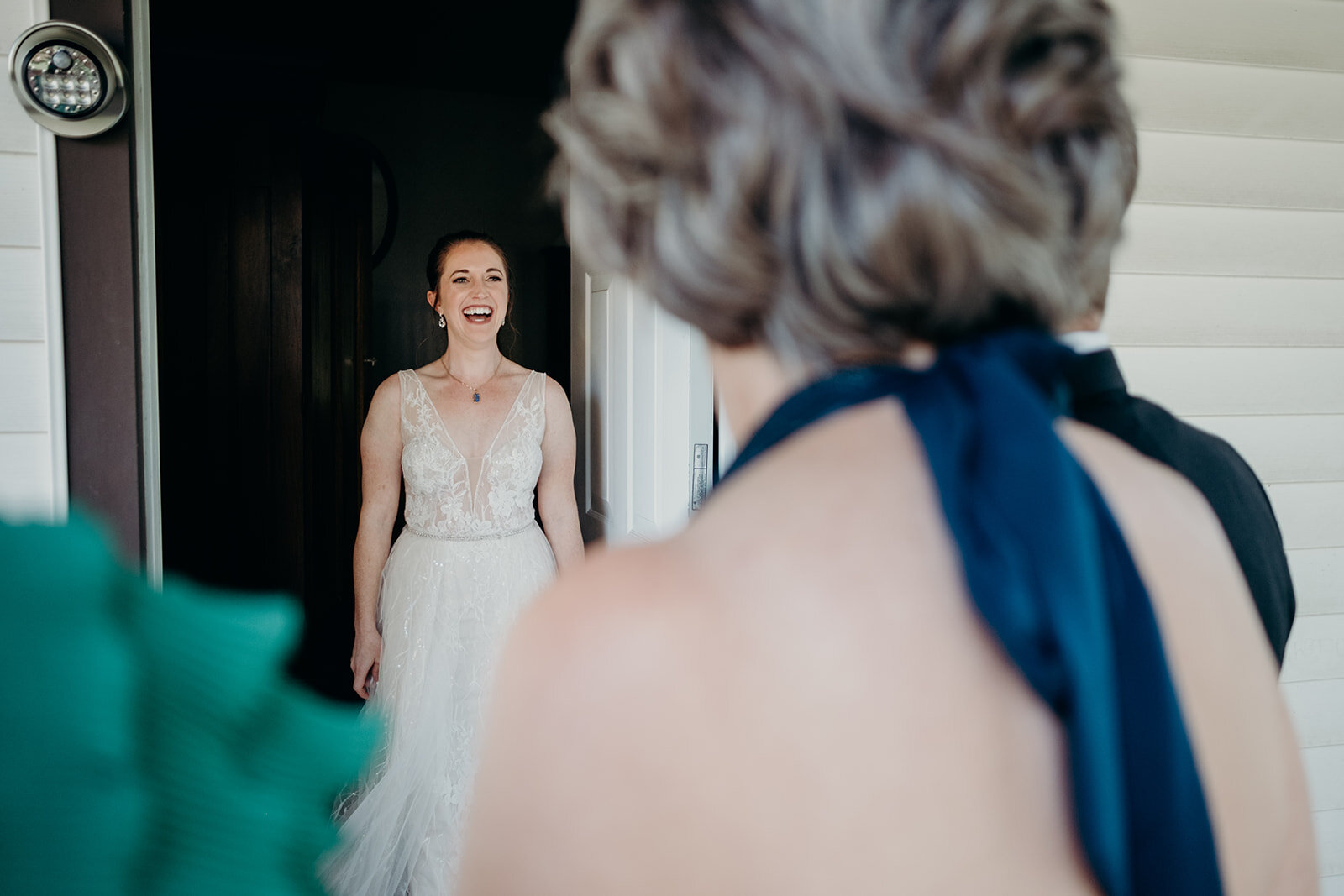 A bride has a moment with her parents before her outdoor farm wedding ceremony.