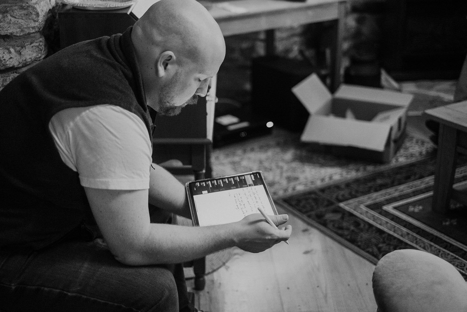 A groom works on his vows before his outdoor farm wedding ceremony. 