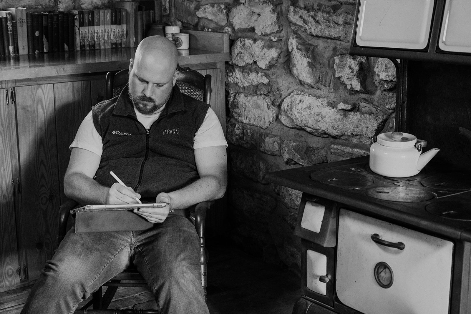 A groom works on his vows in the basement of an old farmhouse before his outdoor wedding ceremony.