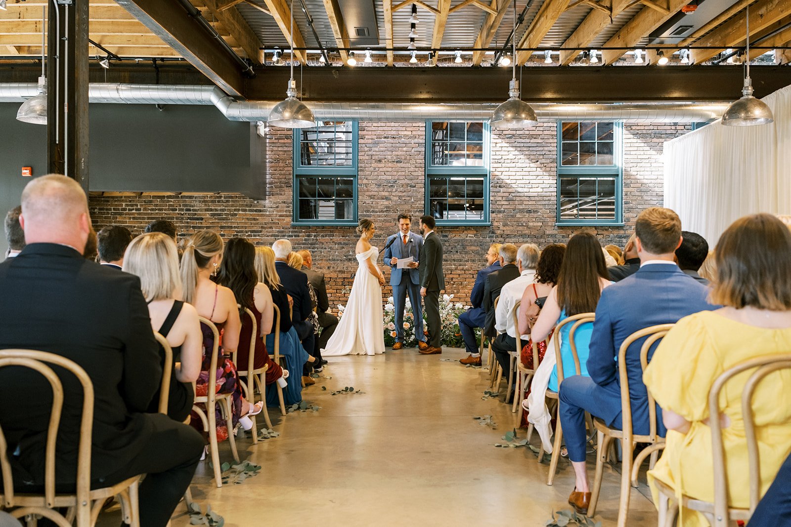 Wedding couple saying vows in the Train Shed room at The Winslow.